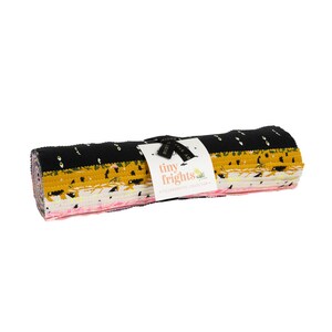 May include: A roll of fabric featuring a variety of prints in black, yellow, pink, and white. The fabric is labelled "tiny frights" and is a collaborative collection.