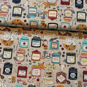 May include: A light beige fabric featuring a repeating pattern of colourful tea tins, teapots, and tiered dessert stands. The design includes various cat illustrations, spoons, and text labels such as Ceylon Tea, Earl Grey, and Cat Mark Mew Mew.
