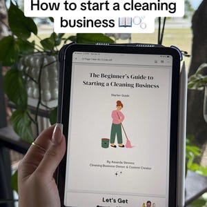 May include: A tablet displays a guide titled "The Beginner's Guide to Starting a Cleaning Business." The cover art features a cartoon person cleaning. The text "How to start a cleaning business" is at the top. A stylus is visible.