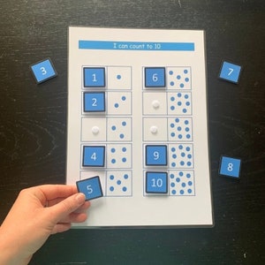 May include: A blue and white learning tool with the text "I can count to 10".  The tool has ten squares with blue dots in each square.  The numbers 1 through 10 are on blue squares below each row of dots.
