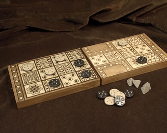 May include: A wooden board game with a decorative design, featuring a grid of squares with various patterns. The game includes light-colored and dark-colored game pieces. The board is set on a brown surface.