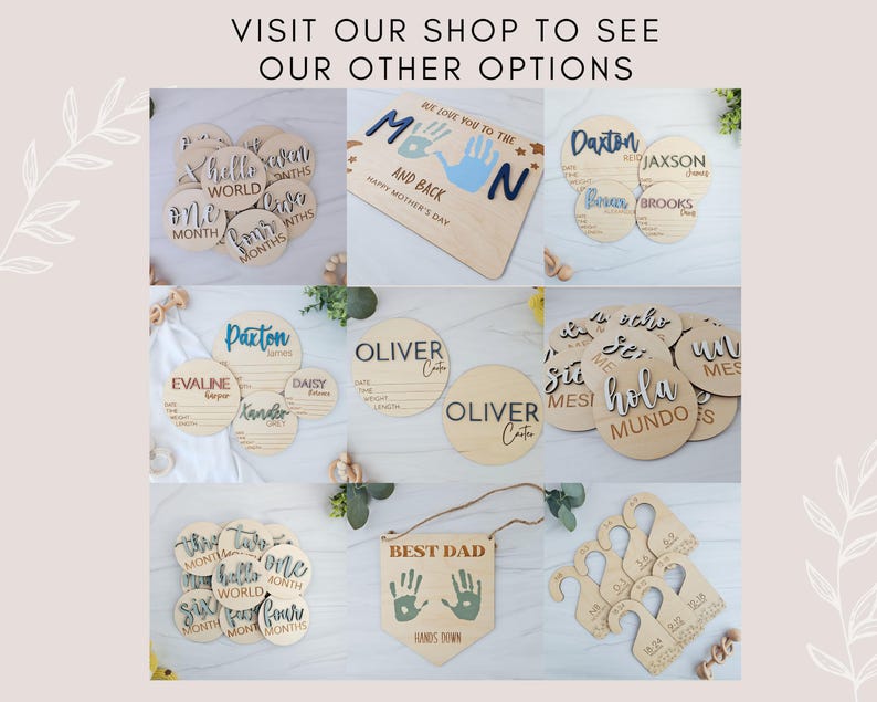 May include: A collection of wooden baby milestone discs with various designs and phrases, including "Hello World", "One Month", "Two Months", "Best Dad", "Hands Down", and "Oliver Cate".
