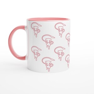 May include: White ceramic mug with a pink interior and handle. The exterior features a repeating pattern of pink cartoon characters. The mug is designed for hot beverages and is suitable for home or office use.
