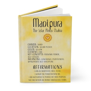 May include: A yellow book with the title "Manipura: The Solar Plexus Chakra". The book has affirmations related to personal power, self-esteem, and confidence.