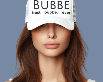 May include: White trucker hat with black text that reads "BUBBE best. bubbe. ever."