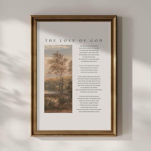 May include: A framed print with the text "THE LOVE OF GOD" at the top. The print features a landscape painting with trees and a body of water. The right side of the print contains a poem. The frame is a warm gold colour.