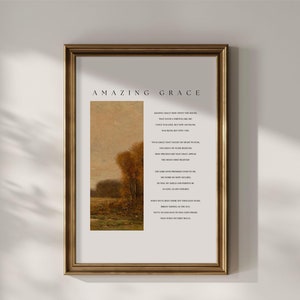 May include: A framed print with a gold frame and a vintage landscape painting. The print features the lyrics to the hymn "Amazing Grace" in black text on a white background.