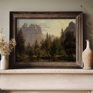 May include: A framed print with a landscape painting of a forest and mountains. The print includes a quote: "God is our portion, Christ our companion, the Spirit our comforter, Earth our lodge, and Heaven our home."