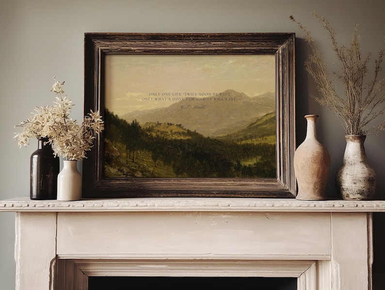 May include: A framed print with a quote by J.G. Holland: "Only one life, twill soon be past, Only what's done for Christ will last." The print features a landscape painting of a mountain range with trees and a valley.
