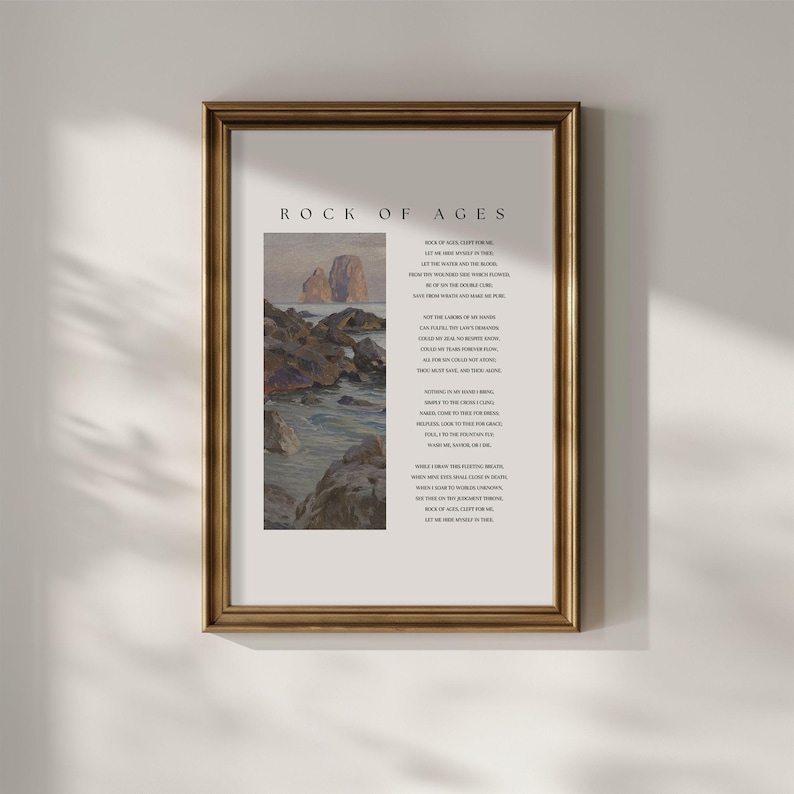 May include: A framed print with a gold-colored frame. The print features a landscape painting of rocks and water, with the words "ROCK OF AGES" at the top and a poem below. The artwork has a vintage aesthetic.