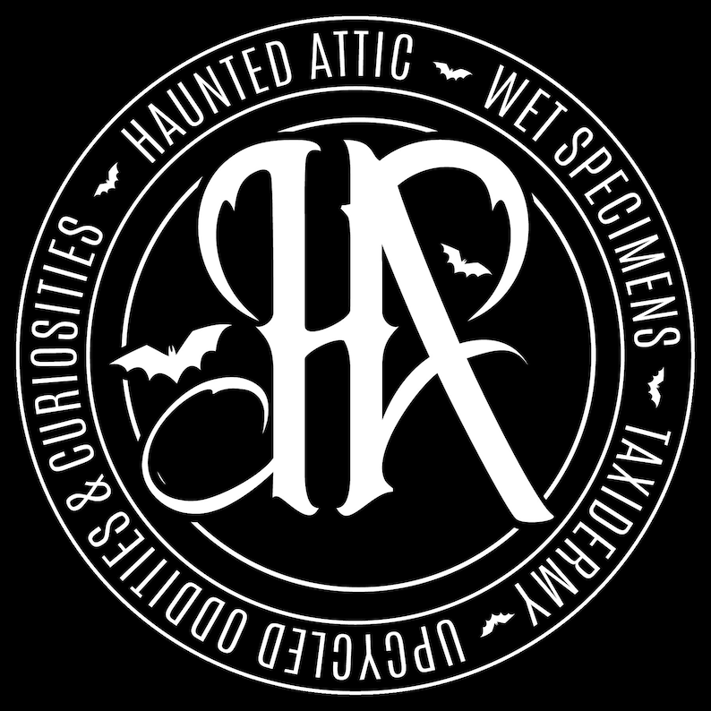 May include: A circular black and white logo with the text "HAUNTED ATTIC" and "WET SPECIMENS TAXIDERMY UPCYCLED ODDITIES & CURIOSITIES". The logo features a stylized "HR" monogram and bat silhouettes.