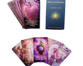 May include: A deck of oracle cards featuring a dark blue box labeled Return to Center, Ask, Shuffle, Listen, and The Answers Are Already Within. The cards display various illustrations including a pink heart, a clock, and text in Spanish.