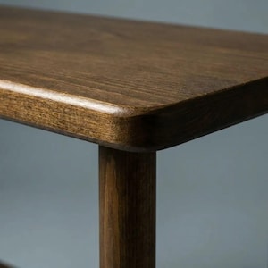 🪵 Narrow Solid Wood 3 Tier End Side Table

Space Saving Slim Book Organizer | Small Spaces Coffee Table for Sofa

Designed for compact living areas, this narrow solid wood 3 tier end side table is the perfect combination of style and functionality.

Its slim profile makes it ideal for placing next to a sofa, couch, or bed, while the three-tier design provides practical storage for books, décor, and everyday essentials.

A beautiful solution for small spaces without compromising on elegance ✨
