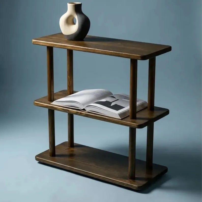 🪵 Narrow Solid Wood 3 Tier End Side Table

Space Saving Slim Book Organizer | Small Spaces Coffee Table for Sofa

Designed for compact living areas, this narrow solid wood 3 tier end side table is the perfect combination of style and functionality.

Its slim profile makes it ideal for placing next to a sofa, couch, or bed, while the three-tier design provides practical storage for books, décor, and everyday essentials.

A beautiful solution for small spaces without compromising on elegance ✨