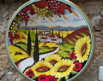 Hand-painted plate with a Tuscan landscape