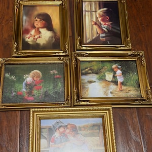 May include: Five framed vintage prints with gold ornate frames. The prints depict children in various scenes, including a girl praying, a boy looking out a window, and children playing outdoors. The frames are rectangular with detailed, decorative edges.