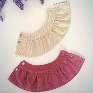 May include: Two fabric collars, one in a cream color with thin white stripes and one in a deep pink color with thin white stripes. Both collars have a ruffled edge and are secured with silver snaps.