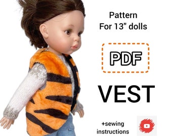May include: A PDF pattern for a vest to fit 13" dolls. The pattern includes sewing instructions and a link to a video tutorial. The image shows a doll wearing a vest with a tiger stripe pattern.