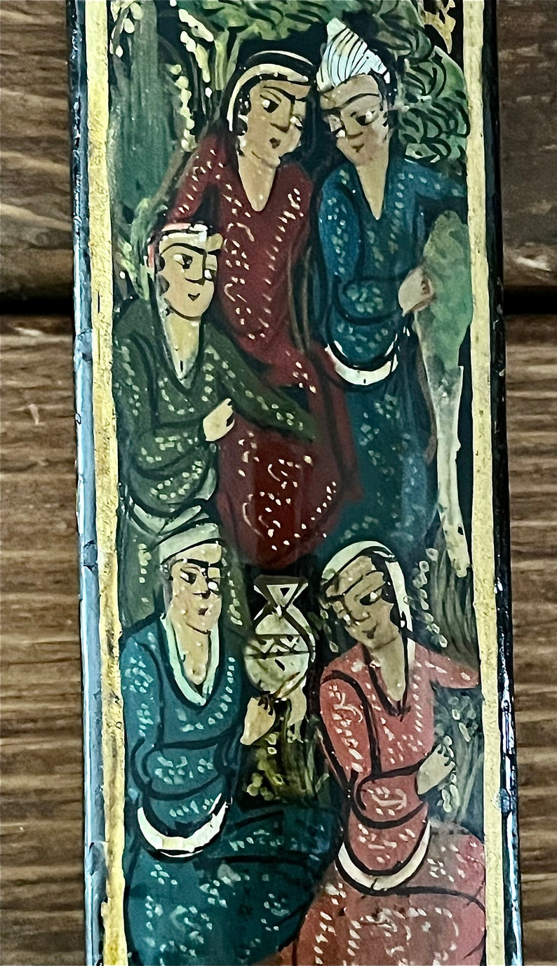 May include: A vintage painting depicting four figures in a forest setting. The figures are dressed in colorful, patterned clothing. The painting is framed in a black and gold frame.
