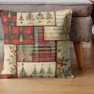 May include: Square decorative pillow with a patchwork design featuring Christmas trees, holly, and plaid patterns in red, green, and cream colors. The pillow is made of fabric and has a stitched border.