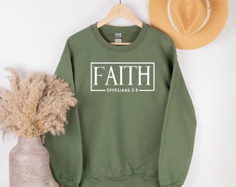 May include: A green sweatshirt with the word "FAITH" in a white box and the text "EPHESIANS 2:8" underneath.