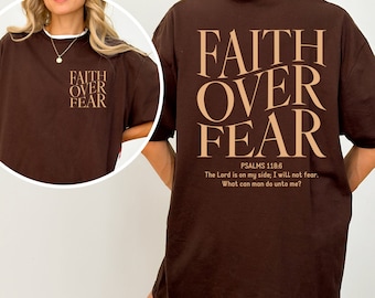 May include: Brown oversized t-shirt with the text "FAITH OVER FEAR" in a light brown color. The back of the shirt has the same text with the addition of "PSALMS 118:6" and the quote "The Lord is on my side; I will not fear. What can man do unto me?"