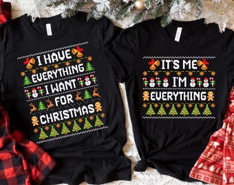 May include: Two black t-shirts with a Christmas-themed design. The left shirt says "I have everything I want for Christmas" and the right shirt says "It's me I'm everything".
