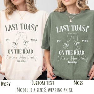 May include: Two t-shirts with the text "Last Toast" and "On the Road Chloe's Hen Party Tenerife" printed on them. The shirts are in ivory and moss green colours.