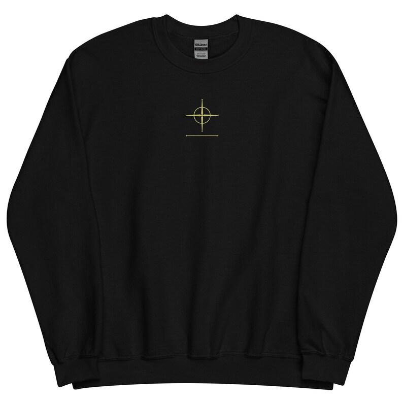 May include: Black sweatshirt with a gold crosshair design on the front.
