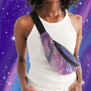 May include: A fanny pack with a black strap and zipper. The bag features a colorful abstract design in shades of purple, blue, and white. The bag is worn across the body.