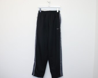 Vintage Nike track pants in black. Best fits M