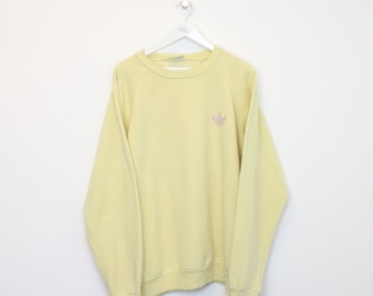 Vintage Adidas sweatshirt in de kleur geel. Past het beste bij XL