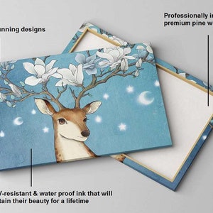 May include: A canvas print featuring a deer with magnolia blossoms growing from its antlers. The background is a light blue with white stars and crescent moons. The print is professionally installed on a premium pine wood frame.