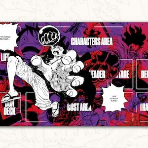 May include: A colorful game mat with a black and white illustration of a cartoon character. The mat has different areas labeled "Characters Area", "Leader", "Cost Area", "Deck", "Trash", and "Dun Deck".