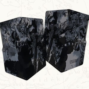 May include: Two black and white wallets with a manga-style illustration. The artwork features a female character with long hair and a detailed background. Text on the wallet reads, "I want to sail out to the sea on an adventure!"