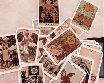 May include: A collection of tarot cards with various illustrations and text, including "Seytan", "Kule", "Olum", "Gunes", "A.F", "XII", "II", and "XVII".