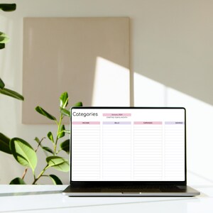 May include: A laptop computer displaying a budget spreadsheet with categories for income, bills, expenses, and savings. The spreadsheet is titled "Categories" and has a section for the starting year and month. The month is January and the year is 2024.