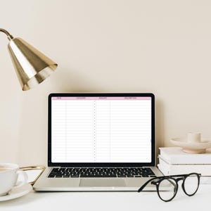 May include: A laptop computer with a blank spreadsheet on the screen. The spreadsheet has columns for date, category, amount, and description. The laptop is on a white desk with a gold lamp, a cup of coffee, and a pair of glasses.