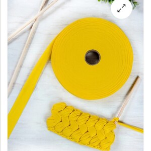 May include: A yellow cotton cord, a roll of yellow cotton cord, and a yellow crocheted piece. The cord is used for crocheting.