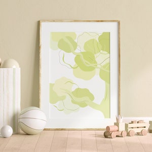 May include: A framed print of an abstract green tree with a white background. The print is hanging on a light green wall with a white vase with green stripes and white spheres in front of it. A white and green striped ball and a wooden toy train are also in the image.