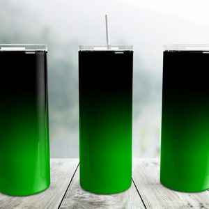 May include: Three stainless steel tumblers with a black to green ombre design. The tumblers have lids and straws.
