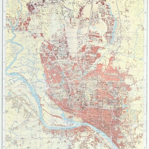 Puede incluir: Un mapa detallado de Dhaka, Bangladesh, con un sistema de cuadrícula y calles etiquetadas. El mapa muestra el río Buriganga y las áreas circundantes.