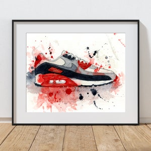 May include: A watercolor painting of a white, gray, and red Nike Air Max 90 shoe with red and black paint splatters on a white background.
