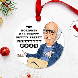 May include: White round Christmas ornament featuring a cartoon illustration of a man with glasses and the text "The Holidays Are Pretty Pretty Prettyyyy Good". The ornament is created in Los Angeles, California.