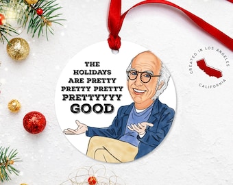 May include: White round Christmas ornament featuring a cartoon illustration of a man with glasses and the text "The Holidays Are Pretty Pretty Prettyyyy Good". The ornament is created in Los Angeles, California.