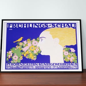 May include: A vintage poster advertising a spring exhibition of arts and crafts. The poster features a woman's face with a bird perched on a branch of flowers. The text reads "Frühlings-Schaue" and "Im Hohenzollern Kunstigewerbehaus".