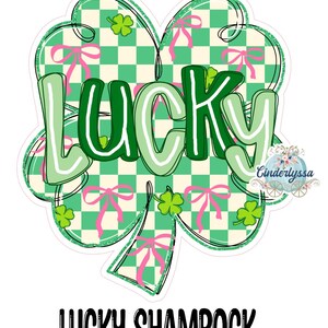 May include: A clover-shaped design with the word "LUCKY" in green and white, set against a green and white checkered background. Pink bows and green shamrocks decorate the design. The text "LUCKY SHAMROCK" is at the bottom.