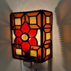 May include: A set of three ceramic mugs with a speckled, matte finish. The mugs are in shades of cream, light brown, and dark brown. Each mug has a simple, minimalist design and a rounded handle. The mugs are stacked on top of each other.