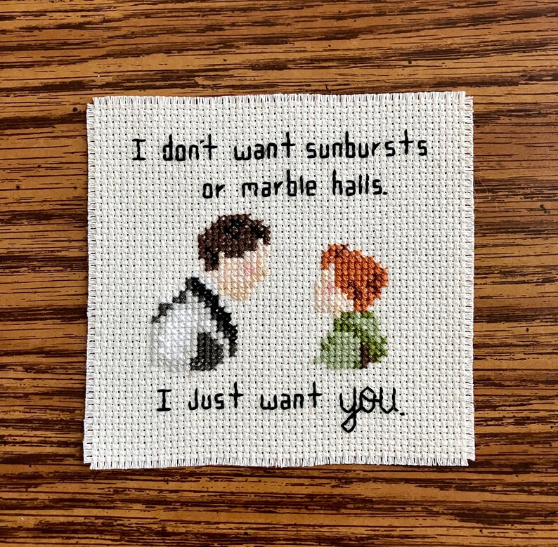 May include: Cross-stitch embroidery with a quote from the movie "The Princess Bride": "I don't want sunbursts or marble halls. I just want you."