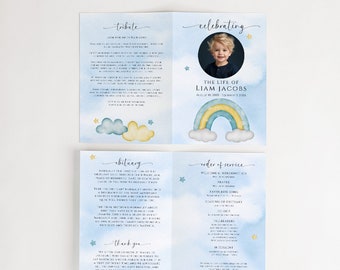 May include: A blue and yellow rainbow with clouds and stars on a light blue background. The text "The Life of Liam Jacobs" is printed below the rainbow. A photo of a young boy is in the top right corner. The text "Celebrating" is at the top of the page. The text "Tribute" is at the top of the left page. The text "Obituary" is at the top of the bottom left page. The text "Order of Service" is at the top of the bottom right page. The text "Thank You" is at the bottom of the left page.
